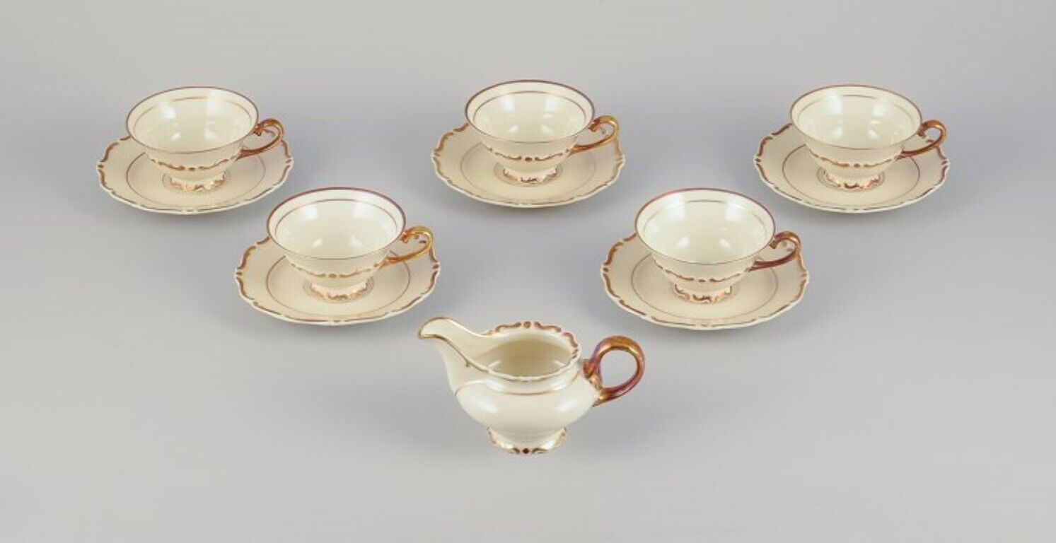 Set of five KP Karlskrona tea cups with saucers and a creamer in porcelain