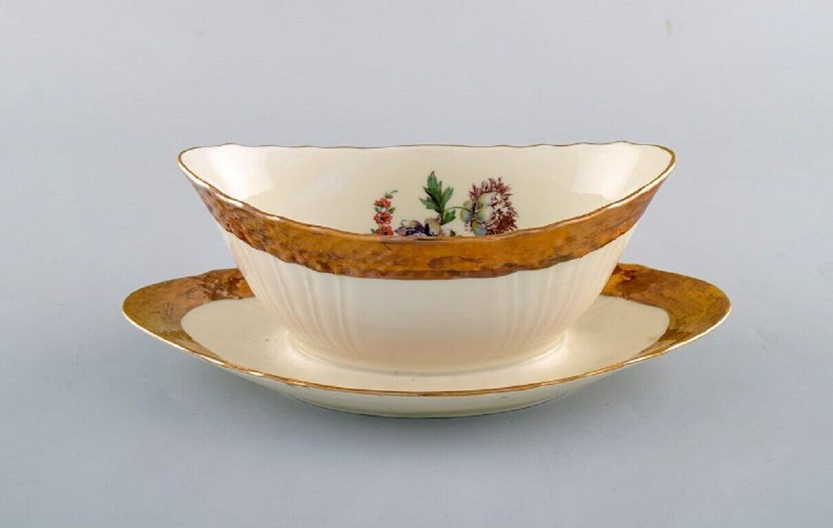 Royal Copenhagen porcelain sauce boat with floral motifs and gold border 2 pcs