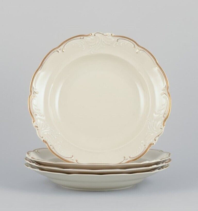 KPM Poland Four large deep porcelain plates in cream color with gold rim