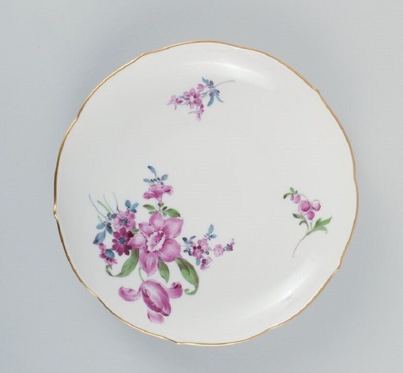 Six antique Meissen plates hand painted with polychrome flowers and gold edge