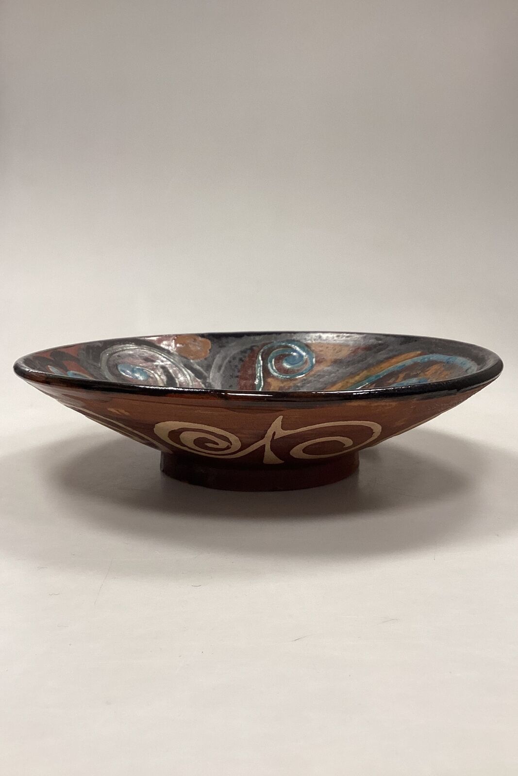 Stoneware bowl in shades of brown yellow and blue