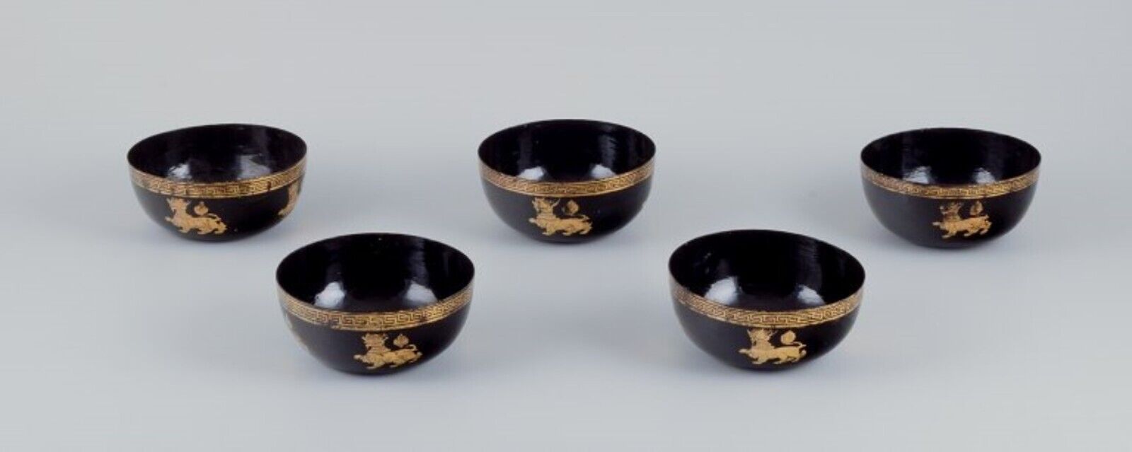 Five Asian bowls made of papier-mâché Decorated in gold and black