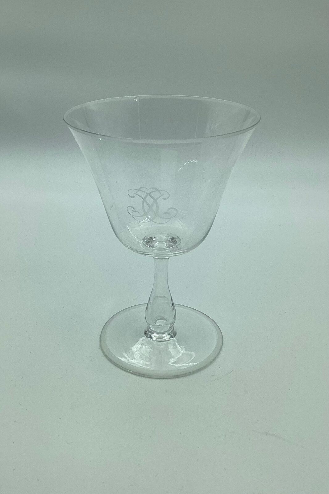 Wine glass with monogram on bell-shaped bowl and hollow stem c 1930-1950