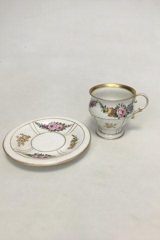 Bing  Grondahl Cup and Saucer in gilt and Polychrome over glaze with floral