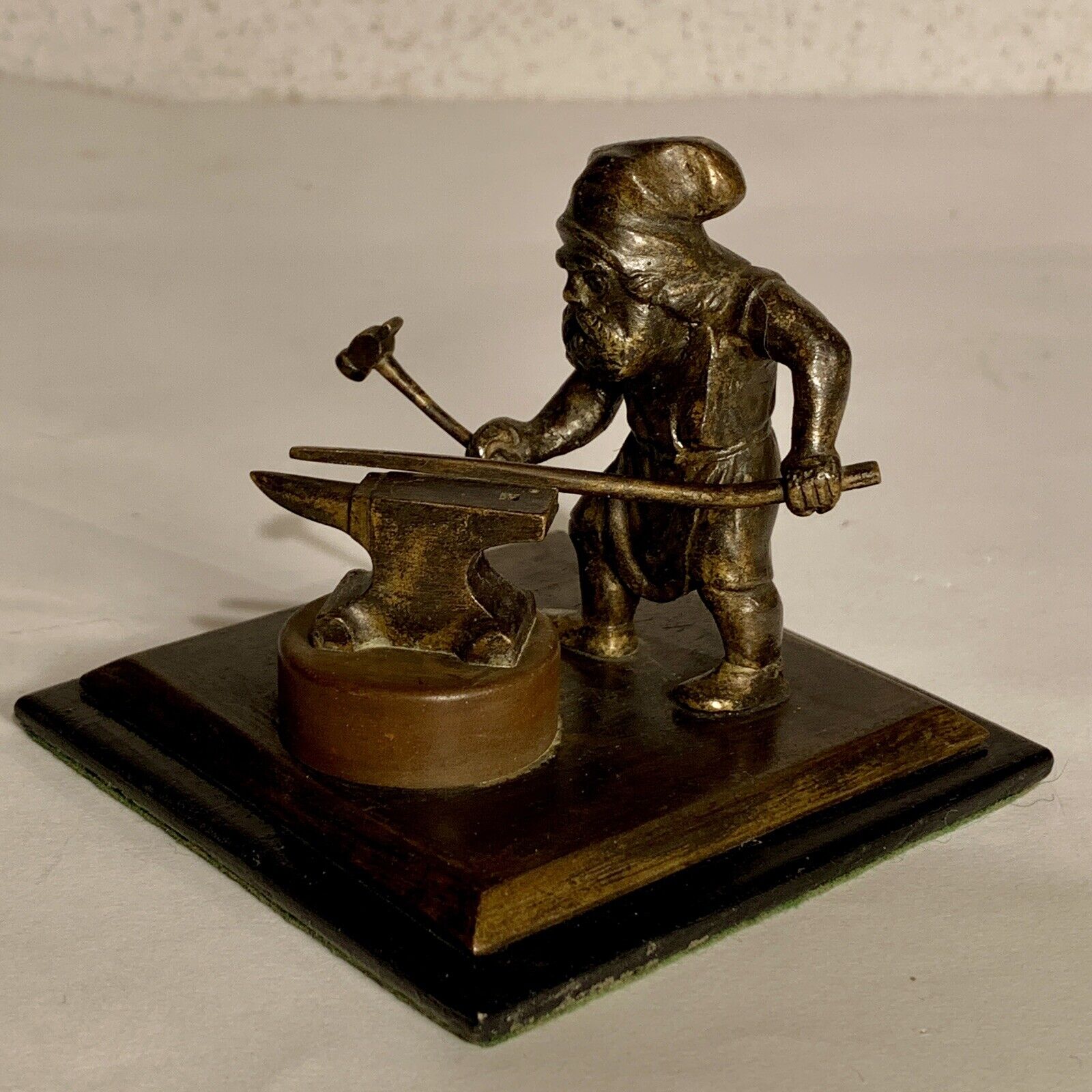 Dwarven blacksmith or gnome with hammer and anvil Antique bronze sculpture