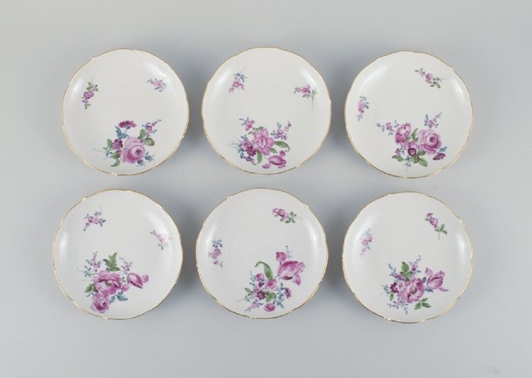 Six antique Meissen plates hand painted with polychrome flowers and gold edge