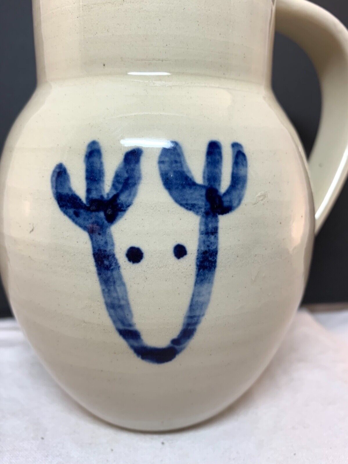 Studio pottery white jug vase with cobalt blue reindeer sketch signed 16x13cm