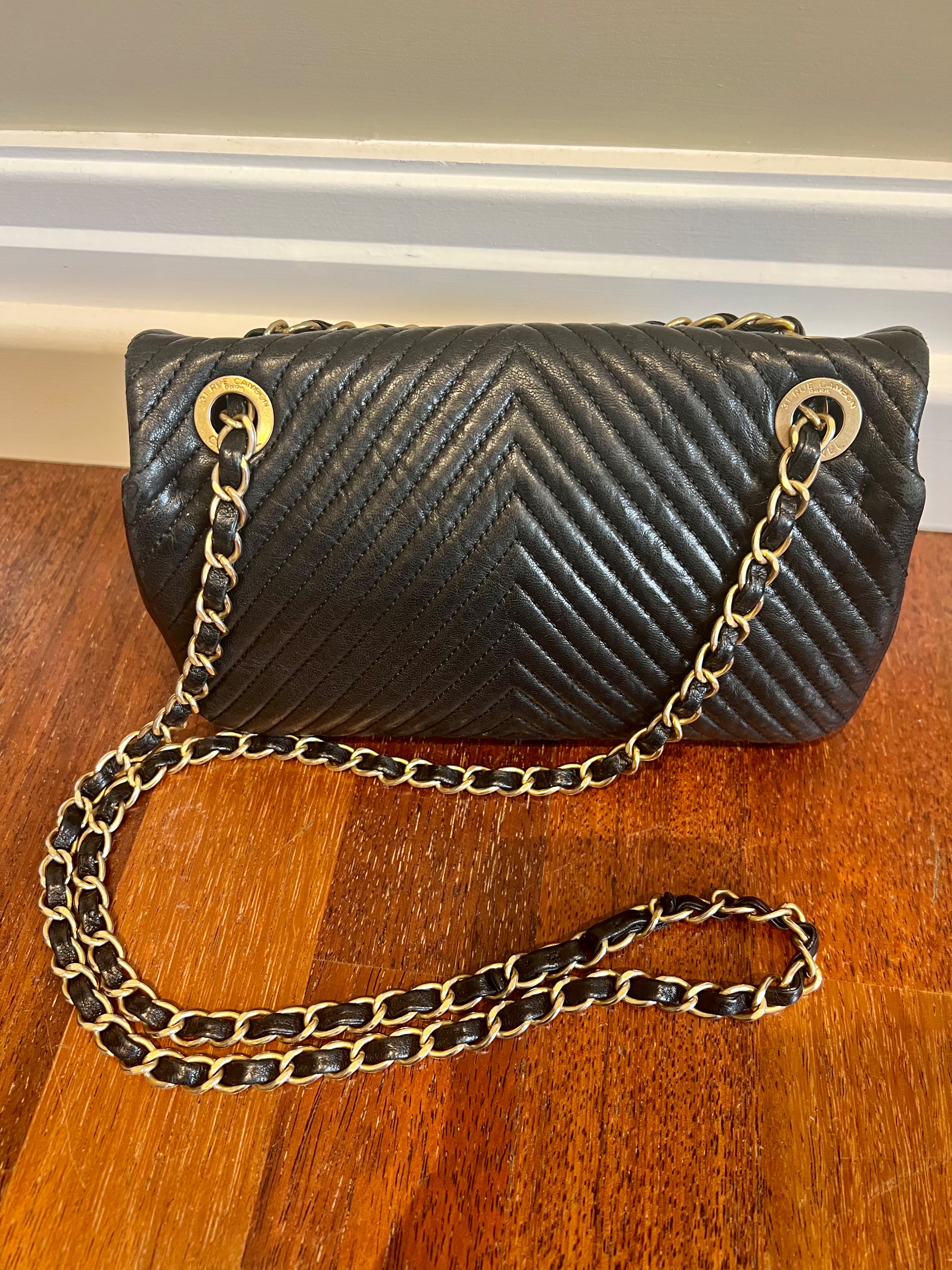 Preowned Chanel black lambskin leather chevron quilted small flap bag