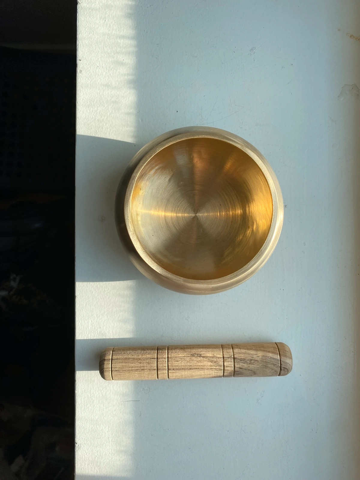 Brass singing bowl with wooden mallet