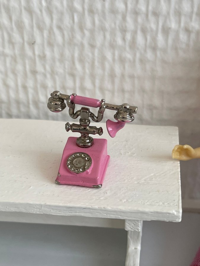 Rosa telefon i miniatyr