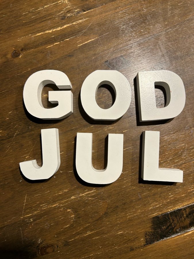 Vita bokstäver "God Jul"