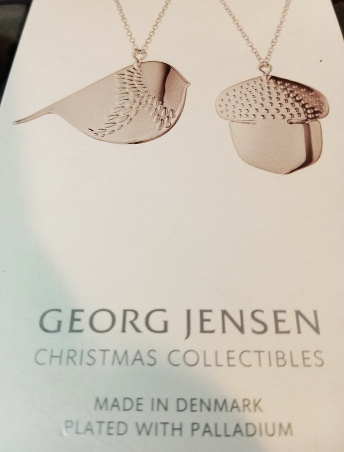 Två julgranshängen från Georg Jensen. Ekollon och Vinterfågel