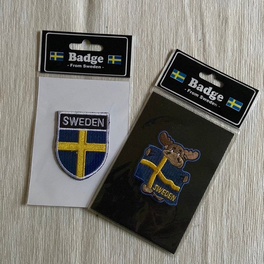 Badge, älg och vapensköld