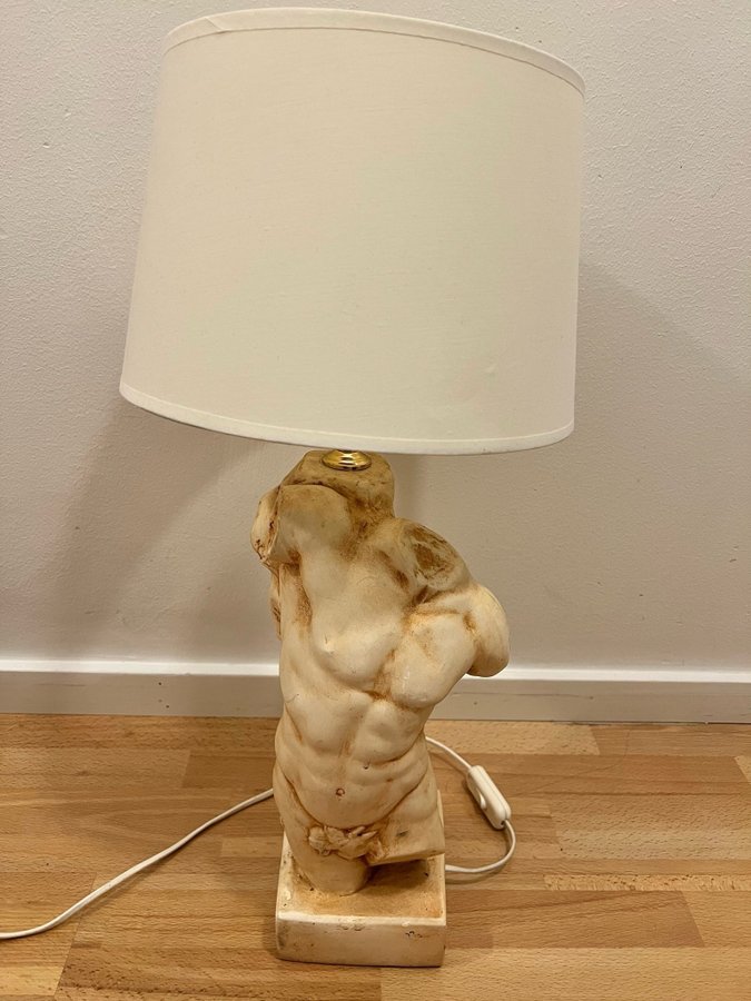 Säljer en bordslampa med en staty av en manlig torso