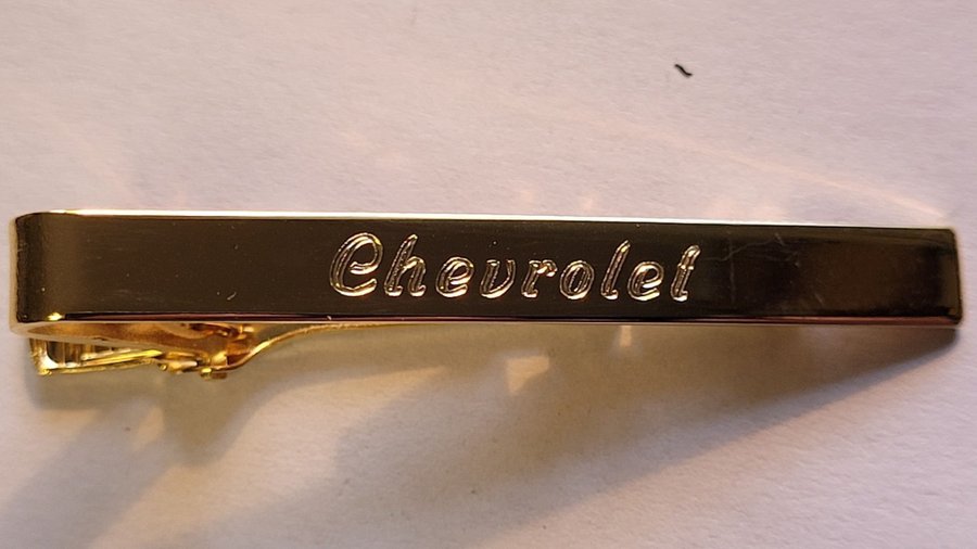 Chevrolet slipshållare i gulmetall