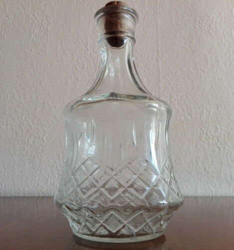 Clear vintage glass carafe, decanter with cork