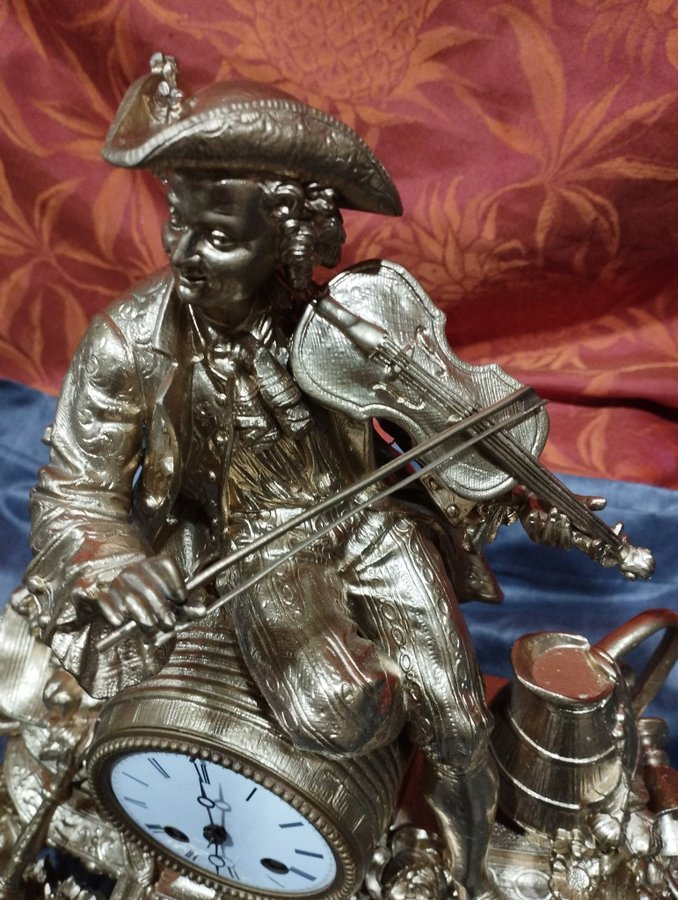 Antique gilt regule table clock: violinist with pendulum bell and key