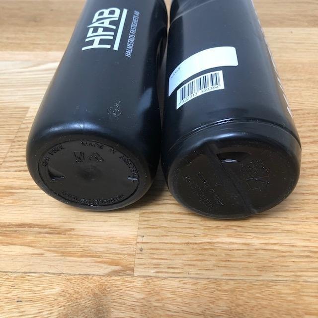 Two black plastic portable water bottles