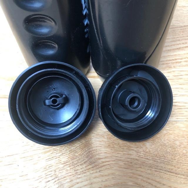 Two black plastic portable water bottles