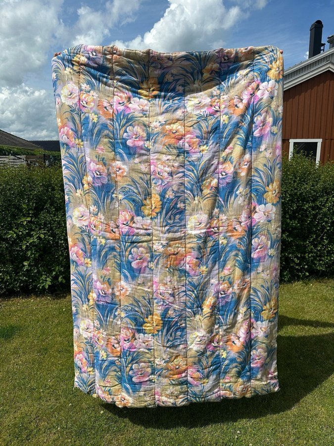 Vackert blommigt retro täcke i fina färger!