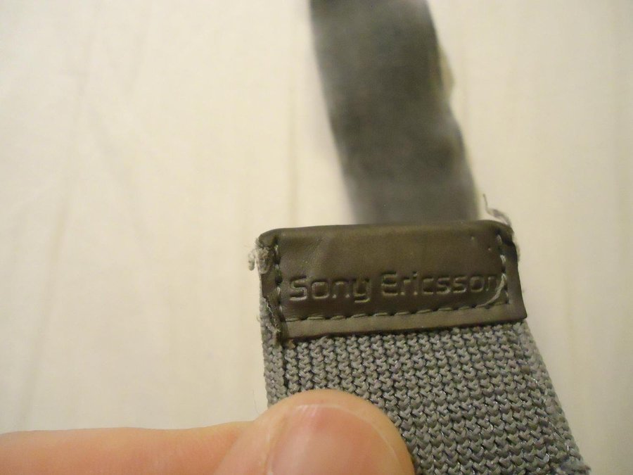 Sony Ericsson elastiskt band med kardborre för telefon alt kamera väskor