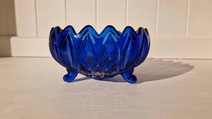 Vacker glas skål med ben i blått
