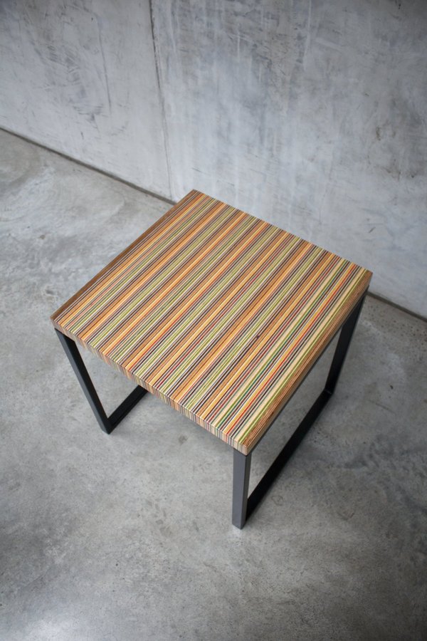 Unique side table or small coffee table made from recycled skateboards