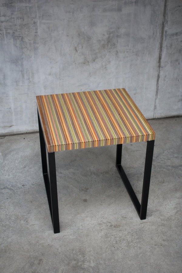 Unique side table or small coffee table made from recycled skateboards