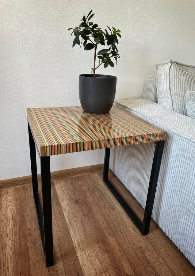 Unique side table or small coffee table made from recycled skateboards