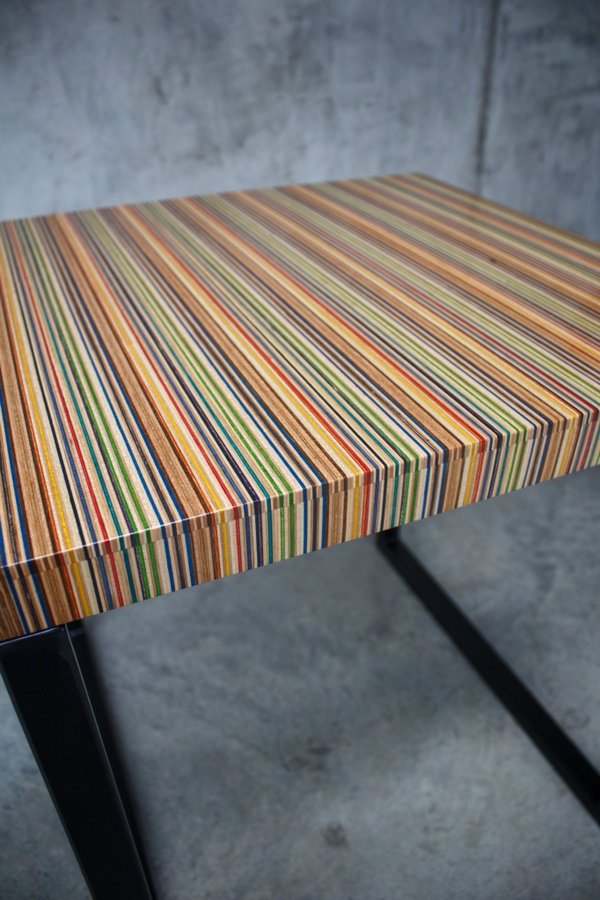 Unique side table or small coffee table made from recycled skateboards