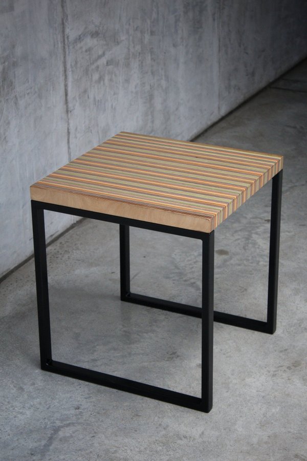 Unique side table or small coffee table made from recycled skateboards