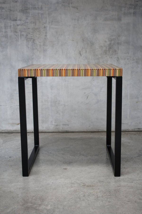 Unique side table or small coffee table made from recycled skateboards