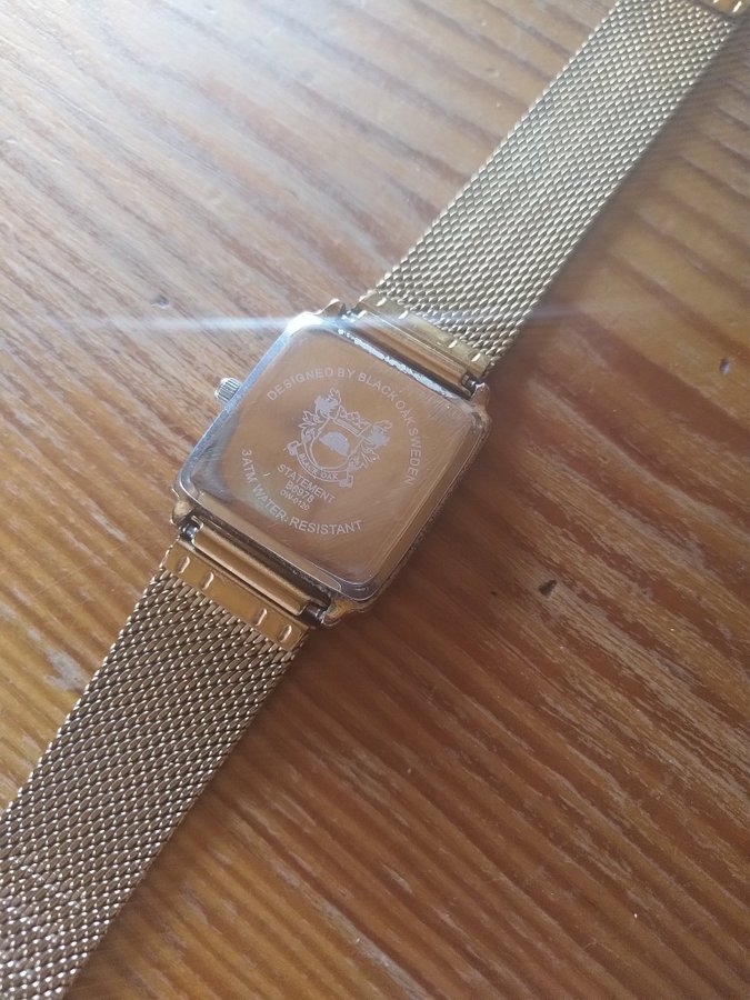 Square Black Oak unisex watch model B6978 in golden tone