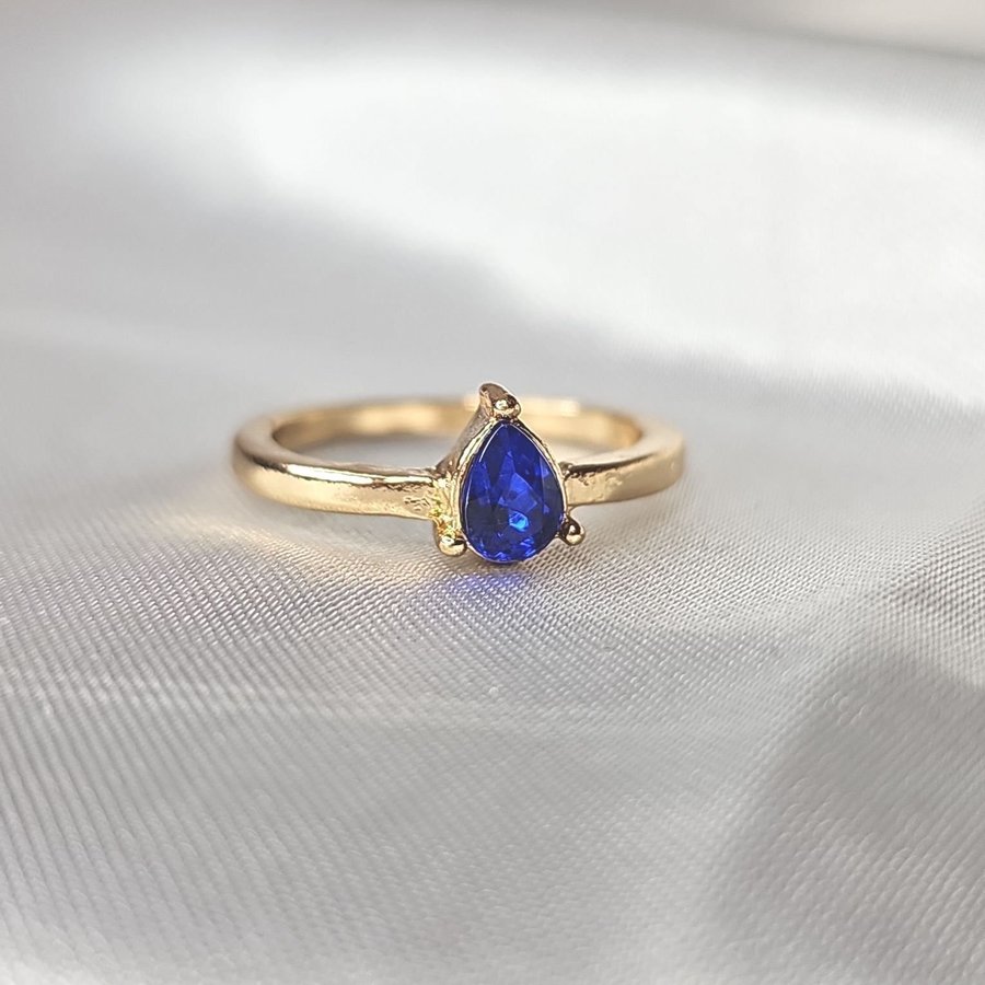 Vacker ring med blå droppformad sten