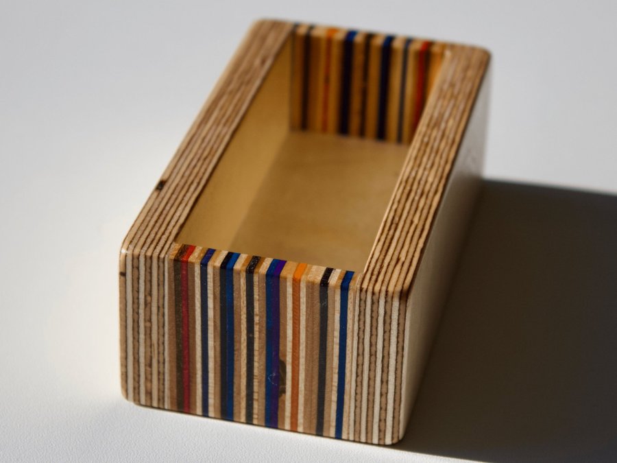 Set of four coasters with holder made from recycled skateboards