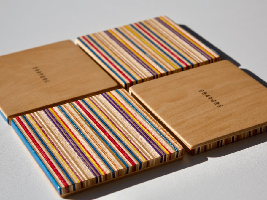 Set of four coasters with holder made from recycled skateboards