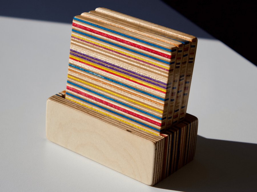 Set of four coasters with holder made from recycled skateboards