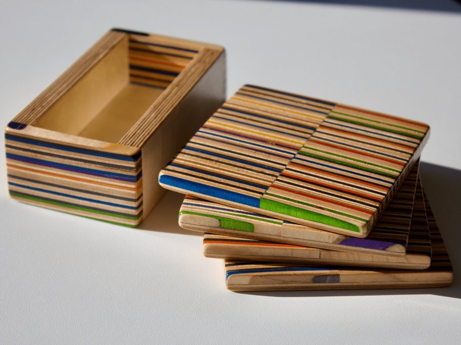 Set of four coasters with holder made from recycled skateboards