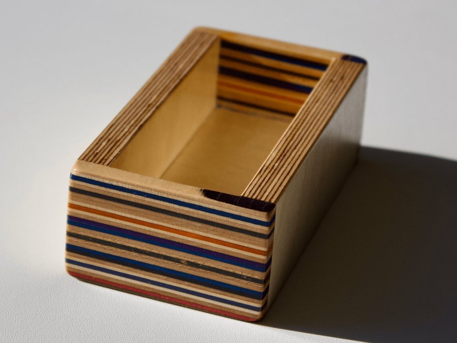 Set of four coasters with holder made from recycled skateboards