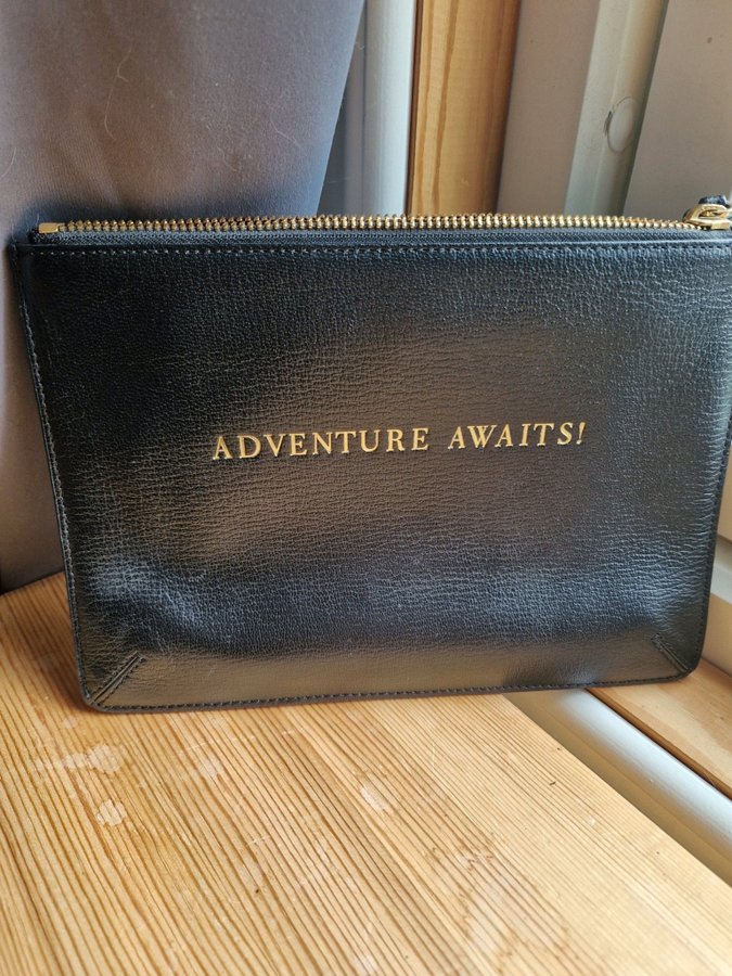 Anya Hindmarch clutch "Adventure Awaits!"