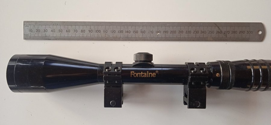 Fontaine rifle scope, zoom, crosshairs, 45mm objective with high mounts.