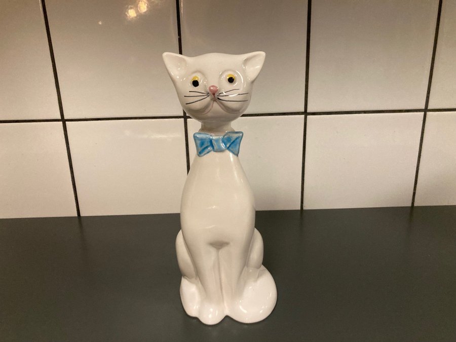 Guldkrokens klassiska katt Figurin i vit porslin med blå rosett