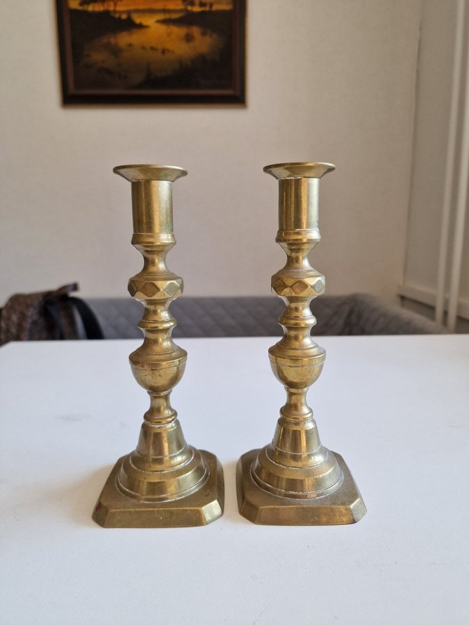 A pair of brozne candle holders