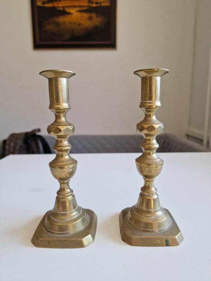 A pair of brozne candle holders