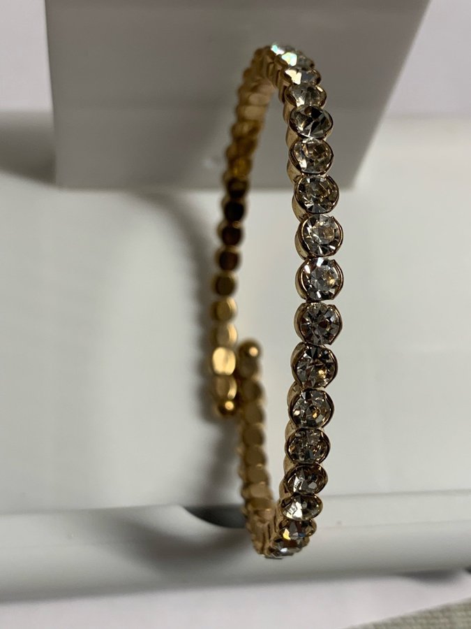 Unused Bracelet in Gold Toned metal and Clear Rhinestones