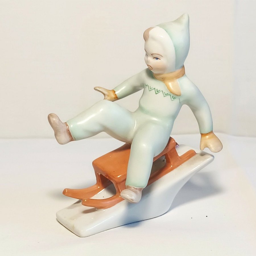 Hungary - Vintage Porcelain Figurine of a Boy on a Sled - Ungern