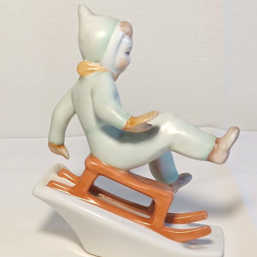 Hungary - Vintage Porcelain Figurine of a Boy on a Sled - Ungern